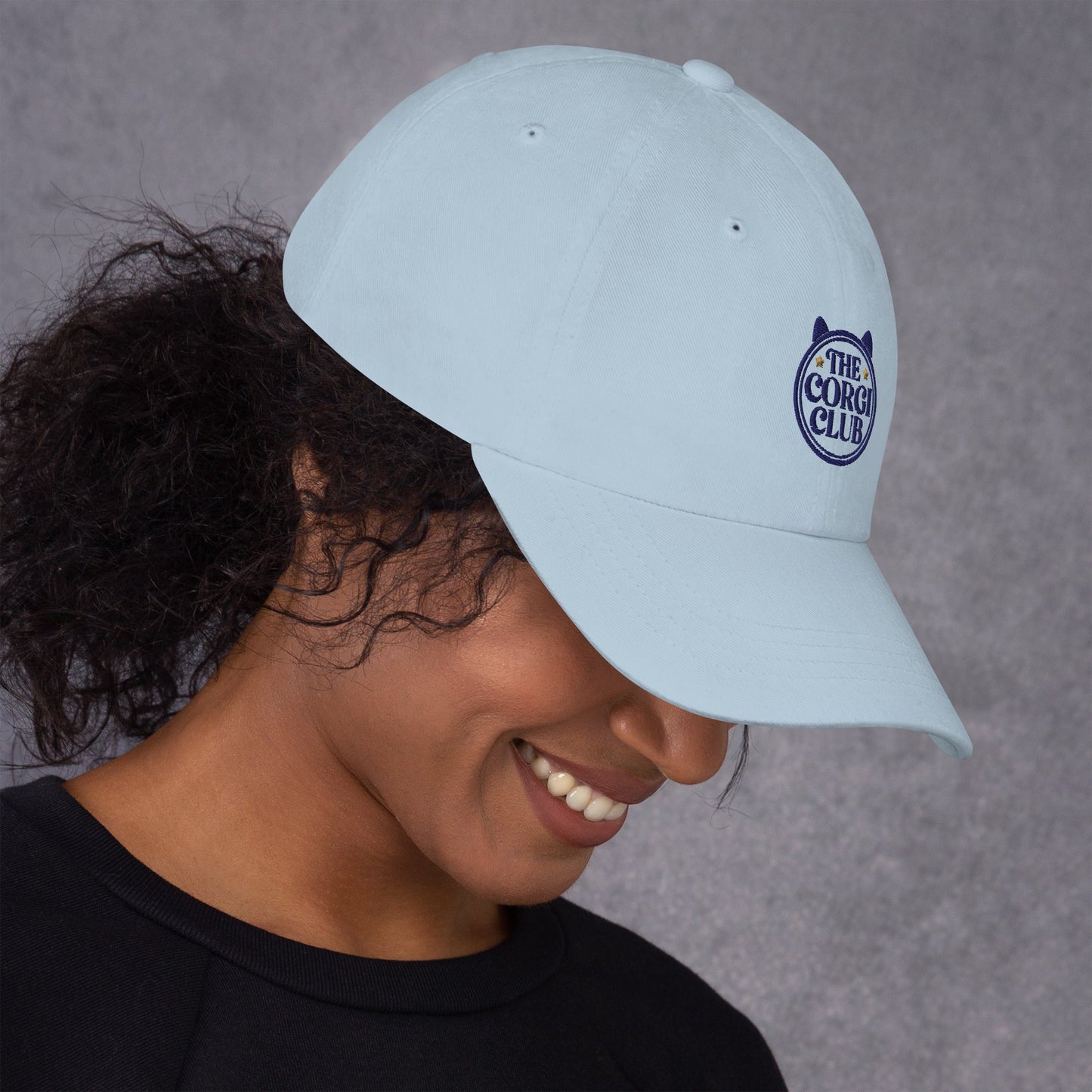 Lifestyle shot of the embroidered Corgi cap, The Loyal Mark