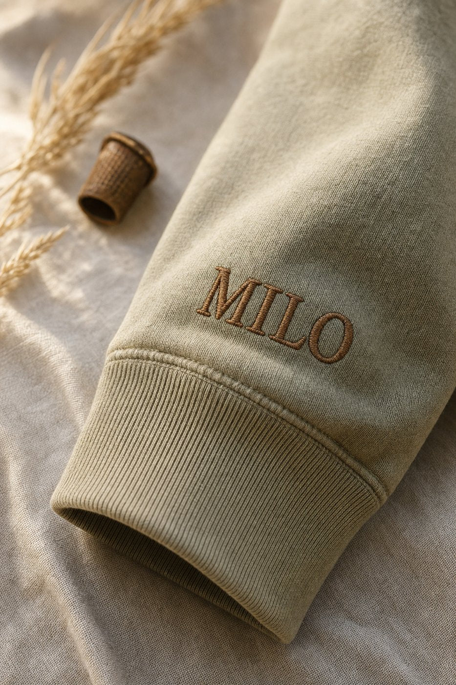 MILO embroidered on heavyweight cotton sleeve in cognac thread